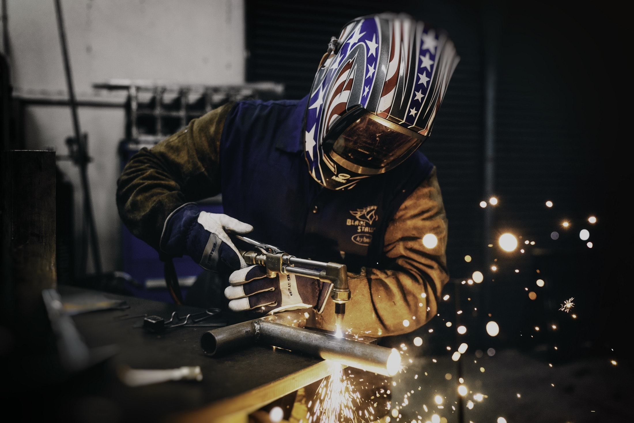 welder with American flag helmet. Welding Careers for Veterans at ETI School of Skilled Trades