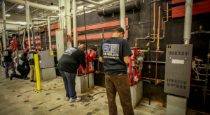 Two male HVAC students are working in ETI's lab on campus